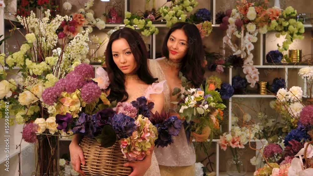 Florists. Asian women happy working in flower store Florists. Asian women happy working in flower store