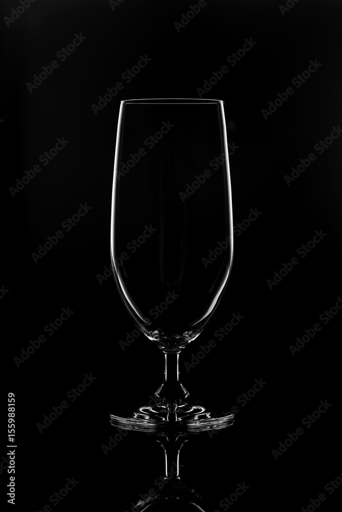 Transparent glass for wine on a black background. Transparent glass for wine on a black background.