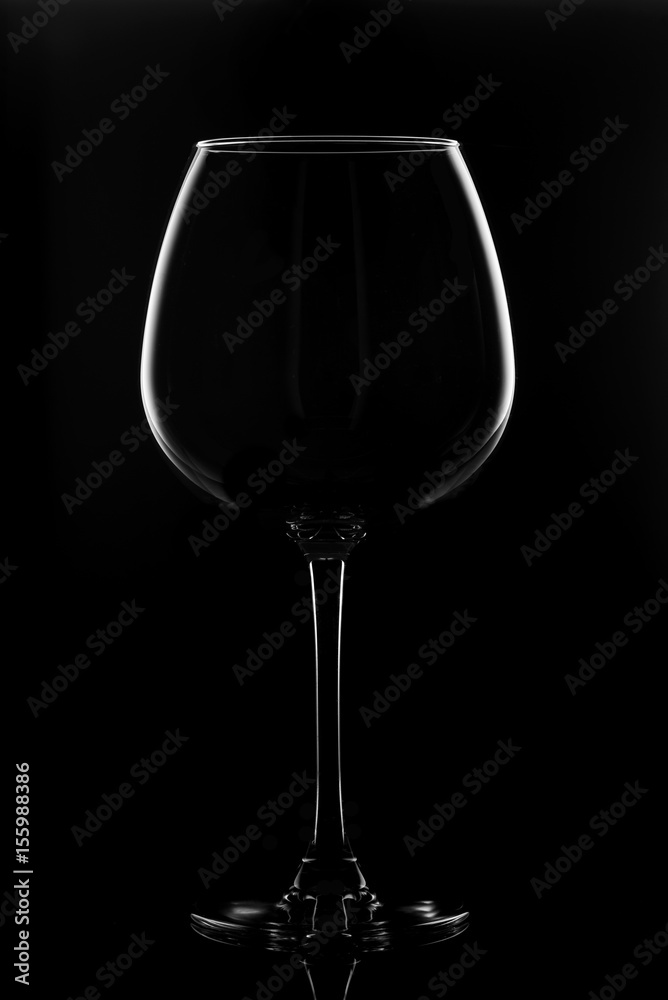 Transparent glass for wine on a black background.