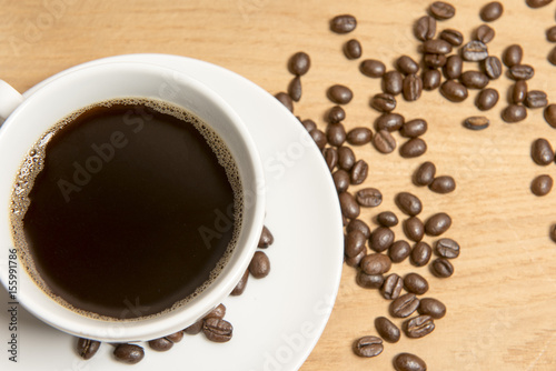 Coffee with coffee beans on a wooden background 
