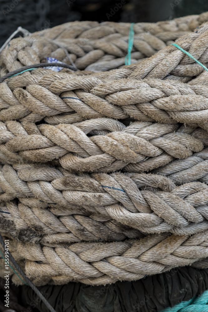 Closeup view to stacked and knotted old rope Closeup view to stacked and knotted old rope