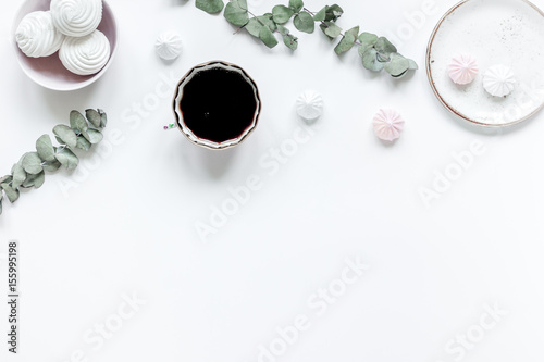 woman desk with plant, coffee and marsh-mallow in spring desing on white background flat lay mock-up