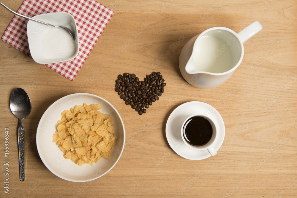 Bowl of cereal with coffee, coffee beans, milk and sugar. Bowl of cereal with coffee, coffee beans, milk and sugar.