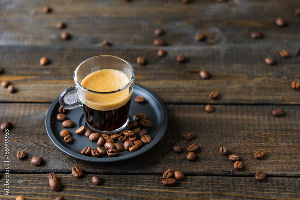 Φωτογραφία A cup of espresso and coffee beans on a wooden table