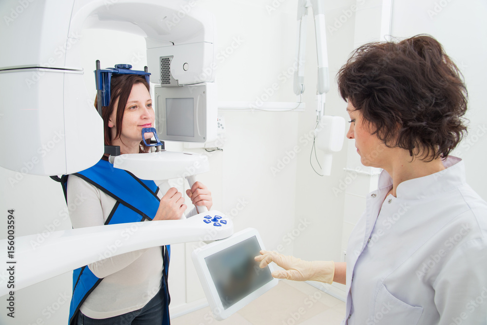 Dentist taking a panoramic digital X-ray of a patient s teeth Dentist taking a panoramic digital X-ray of a patient s teeth