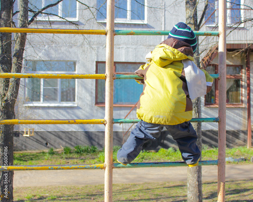 little boy, in kindergarten, on the Playground, climbs on the Swedish ladder. The child climbs on the Playground.. © Tamara
