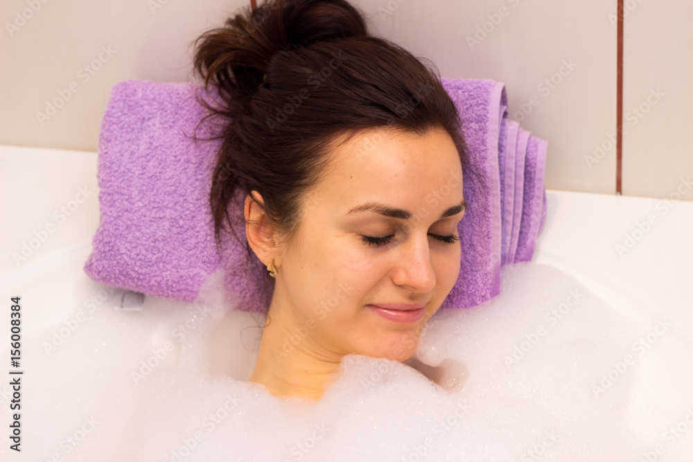 Young woman lying in the bath Young woman lying in the bath