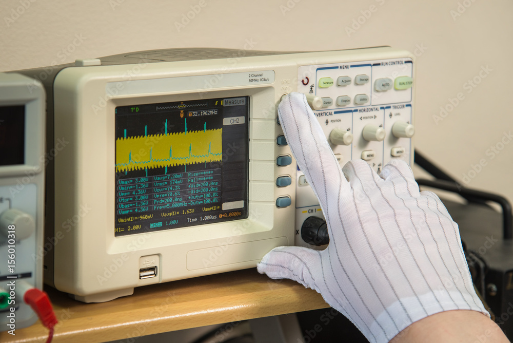 Ταπετσαρία Modern oscilloscope, man's hand adjusting wave signals, closeup