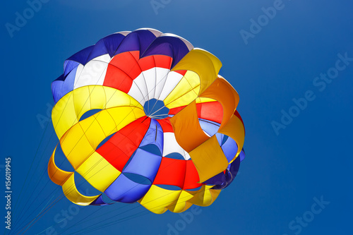 The colorful parachute in the blue sky