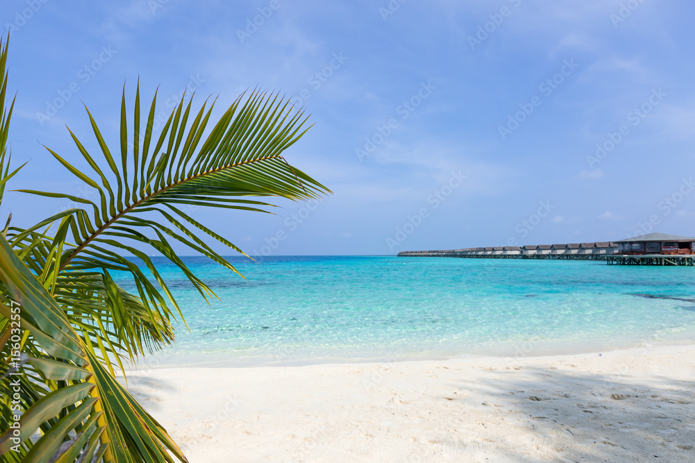 Obraz premium Maldivian wooden bungalows over sea