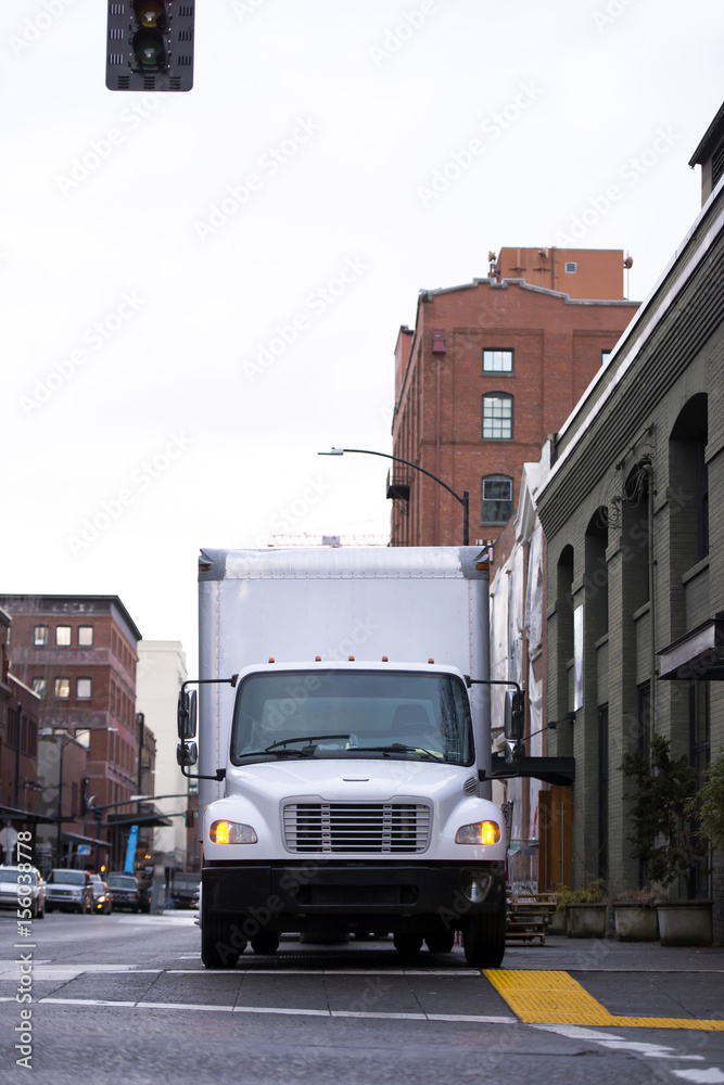 White semi truck for moving and delivery on urban city street