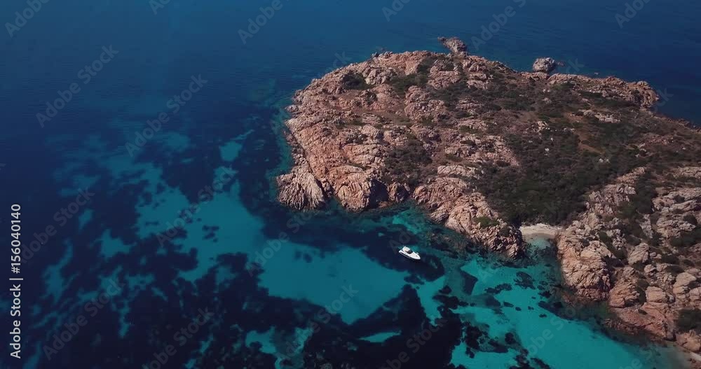Aerial video of boat in front of the island of Mortorio in Sardinia, incredible island of the Emerald Coast in Italy Aerial video of boat in front of the island of Mortorio in Sardinia, incredible island of the Emerald Coast in Italy