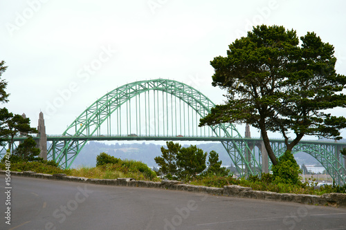 Arched bridge connecting shores bay of Pacific Ocean Newport Oregon © vit