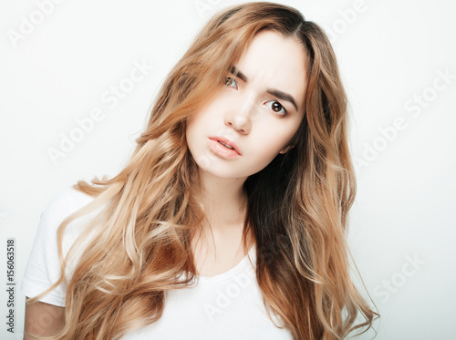 Young beautiful woman posing with white t-shirts, ower white background