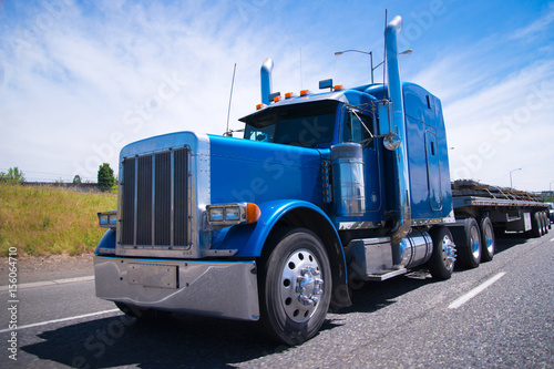 фотографія Big rig semi truck blue wolf of roads
