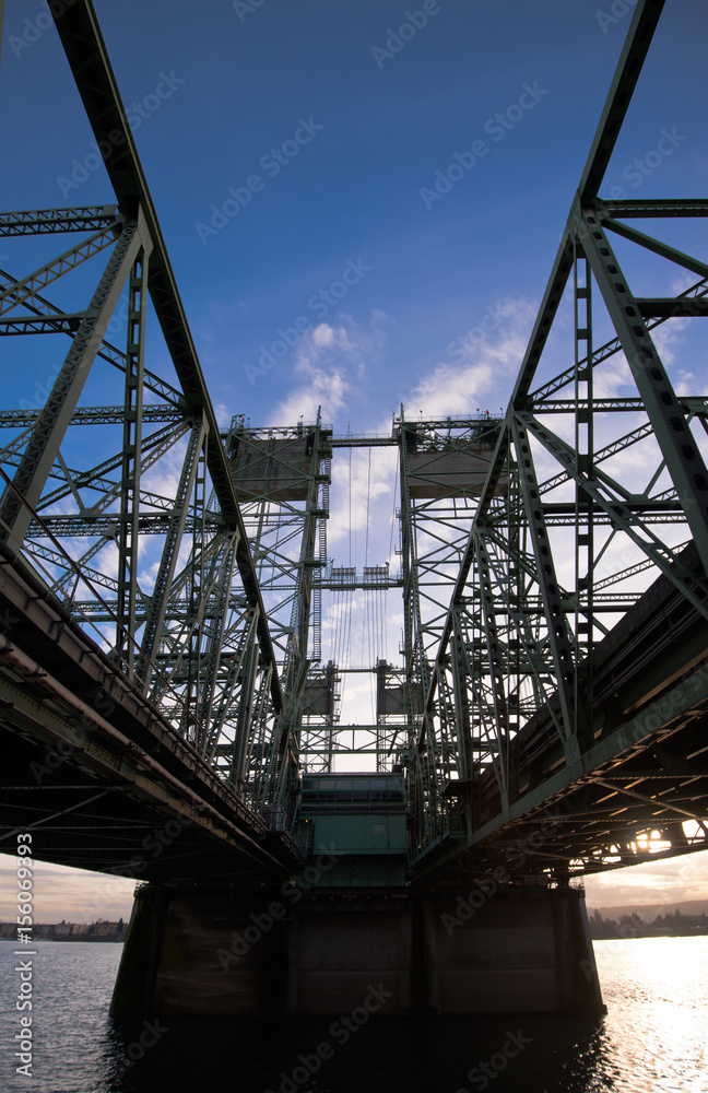 Bridge with steel trusses and lifting towers on a wide concrete support