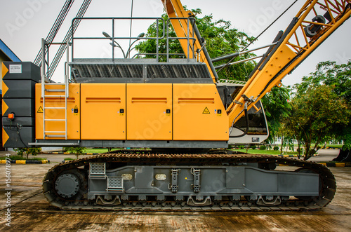 side view of crawler crane, counterweights, big chain and arms