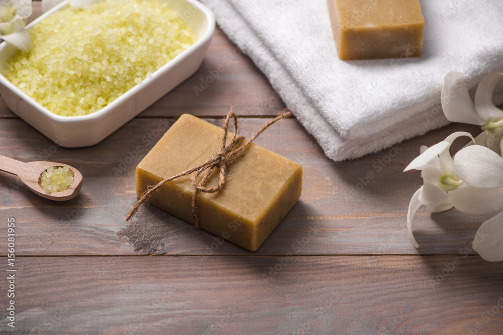 Spa set. Handmade, natural organic soap and white orchid on a wooden background Spa set. Handmade, natural organic soap and white orchid on a wooden background