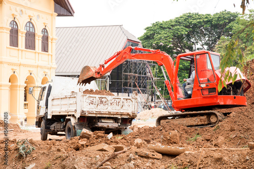 Backhoe loading a dump truck in a quarry
