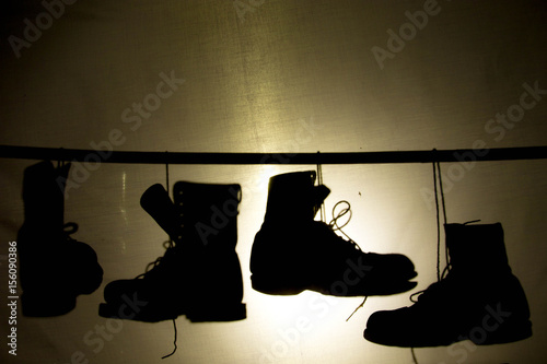Boots shadow at look past canvases background.