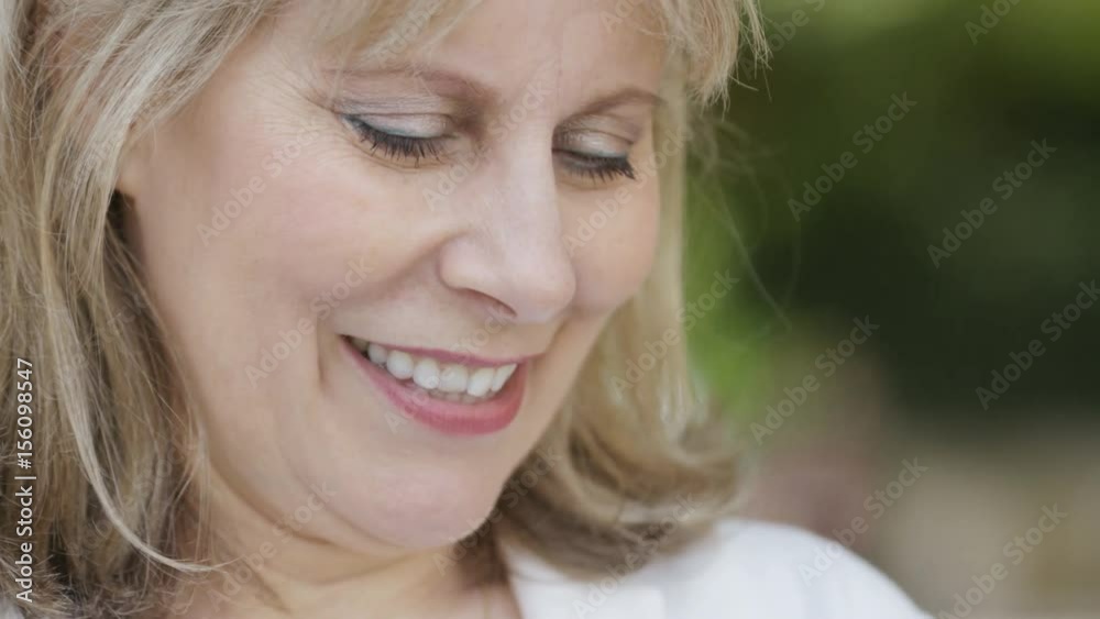 Cheerful and attractive older woman on her phone outdoors Cheerful and attractive older woman on her phone outdoors