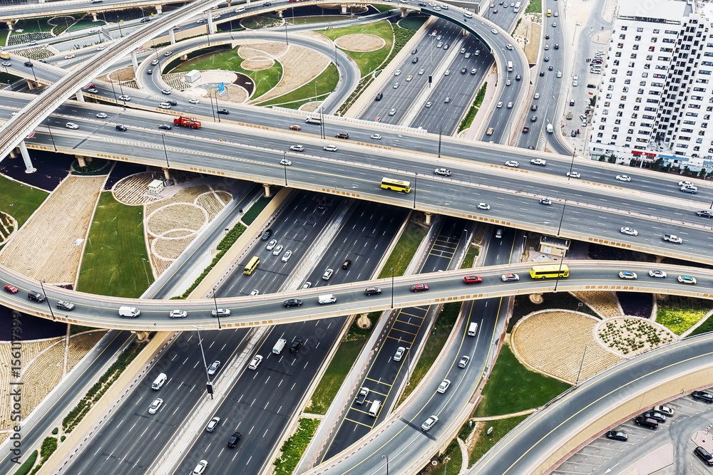 Scenic aerial view of big highway intersection in Dubai, UAE, at daytime. Transportation and communications concept.