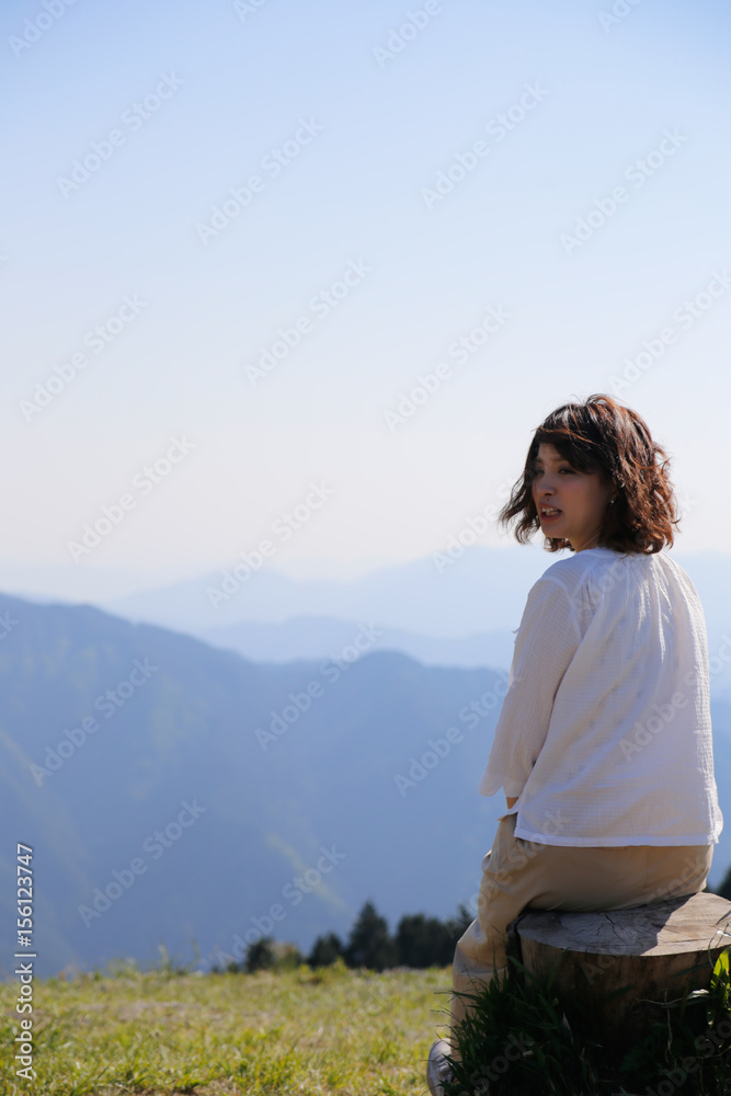 Japanese woman on green mountain