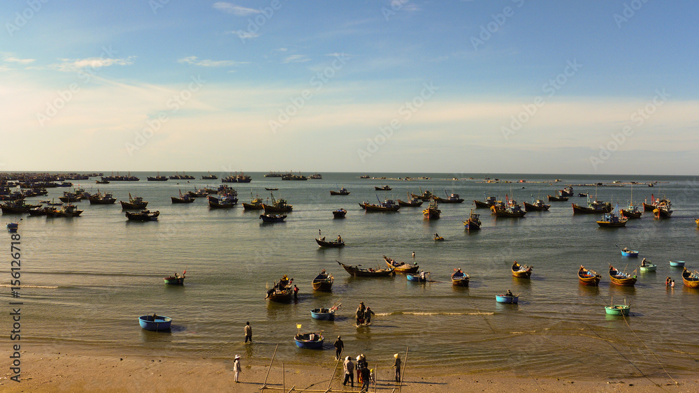 many fishing boats float in the bay , fishing village in Vietnam