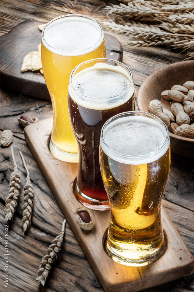Glasses of beer and snacks on the wooden table. Glasses of beer and snacks on the wooden table.