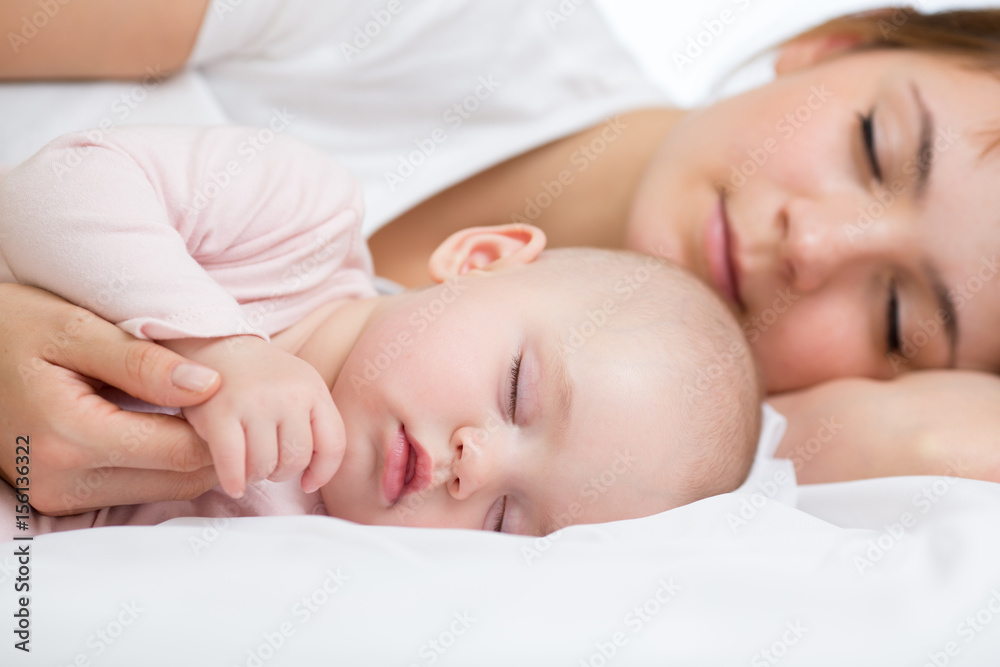 Young mother and her baby, sleeping in bed Young mother and her baby, sleeping in bed