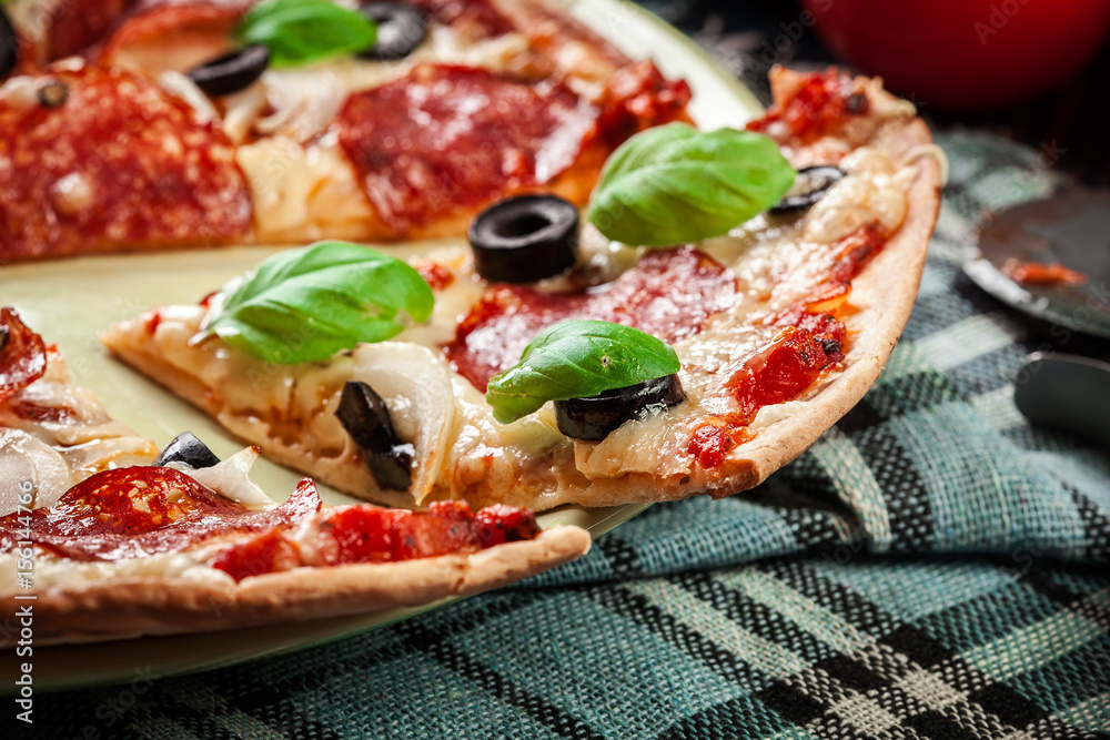 Pizza pepperoni with olives served Pizza pepperoni with olives served