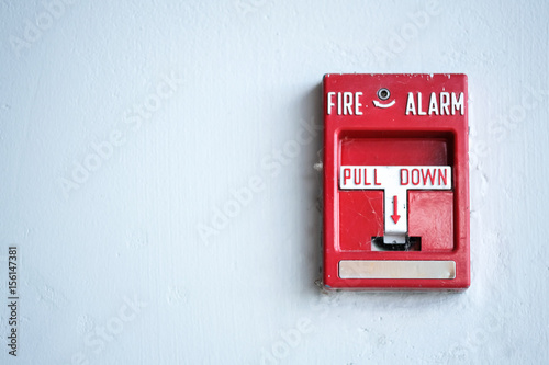 The red fire alarm.