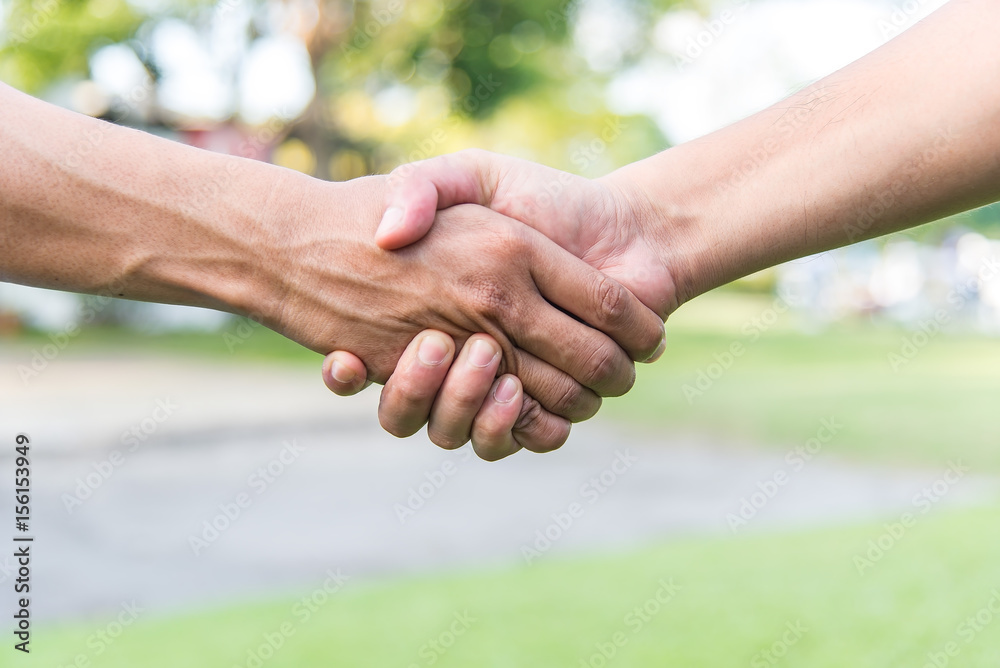 Close up of men and women holding hands Close up of men and women holding hands