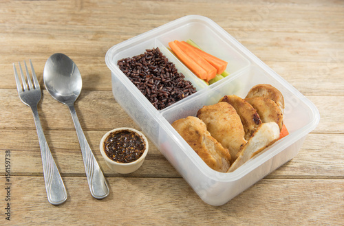 Marinated grilled healthy chicken breasts cooked serve with thai spicy sauce and riceberry rice in lunch box,Thai style food