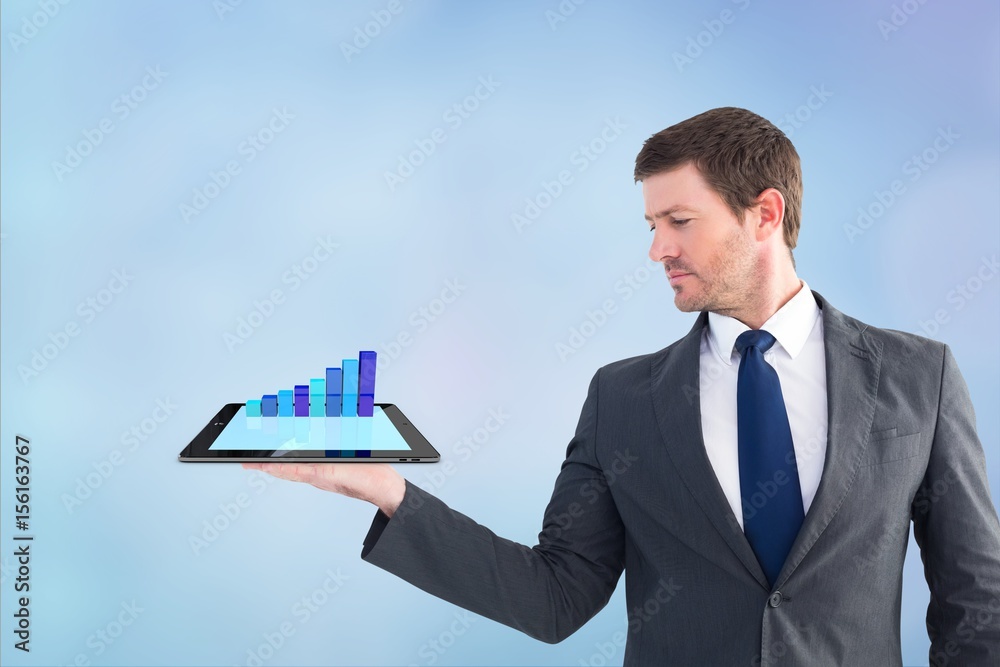 Businessman holding a tablet with graphics Businessman holding a tablet with graphics