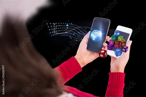 Woman holding two phones with graphics photo