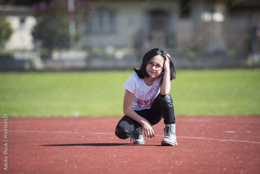 Brunette girl posing on a sports facility