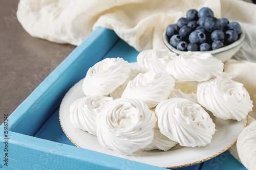 Meringue dessert Pavlova cake with fresh berries on a stone background