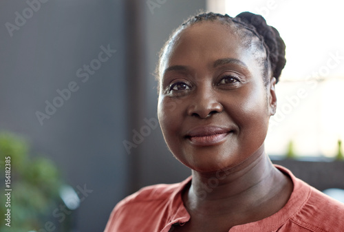 Young African businesswoman smiling confidently in a modern office