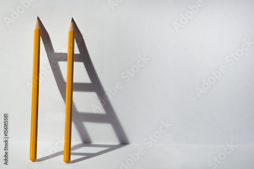 Two pencils and a shadow in...