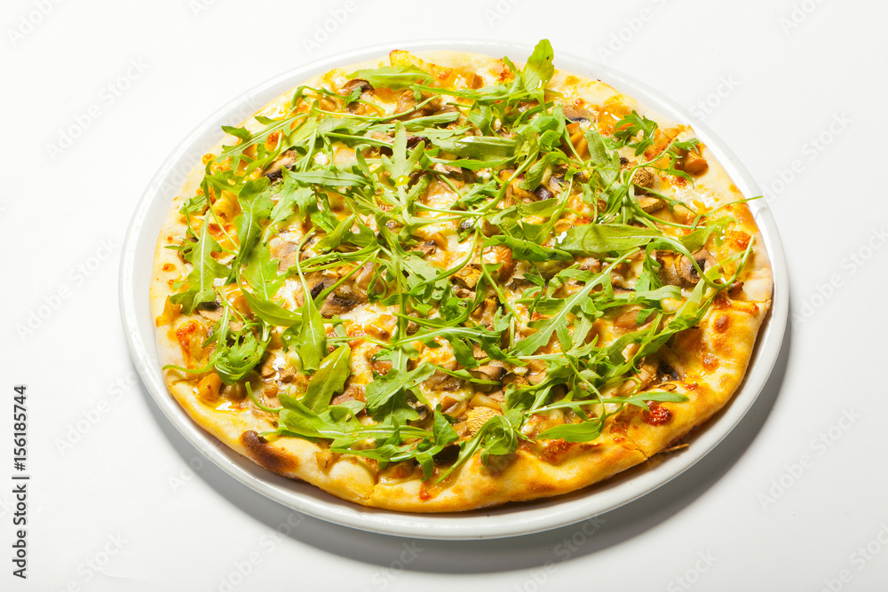 Pizza with mushroom and arugula on a white background Pizza with mushroom and arugula on a white background