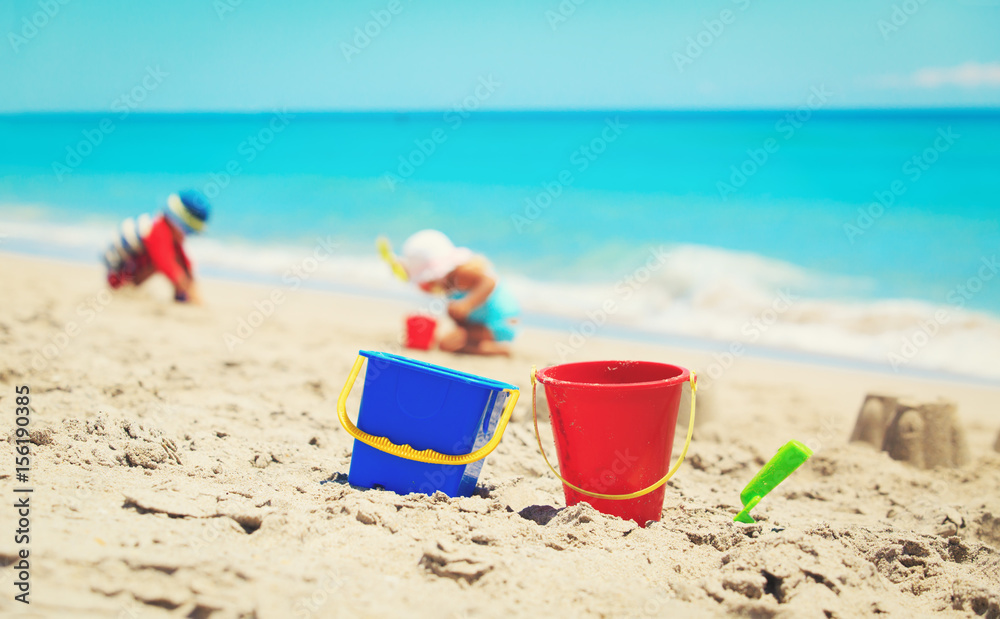 toys and kids playing on the beach toys and kids playing on the beach