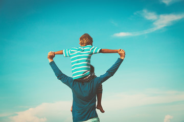 father and son having fun on sky