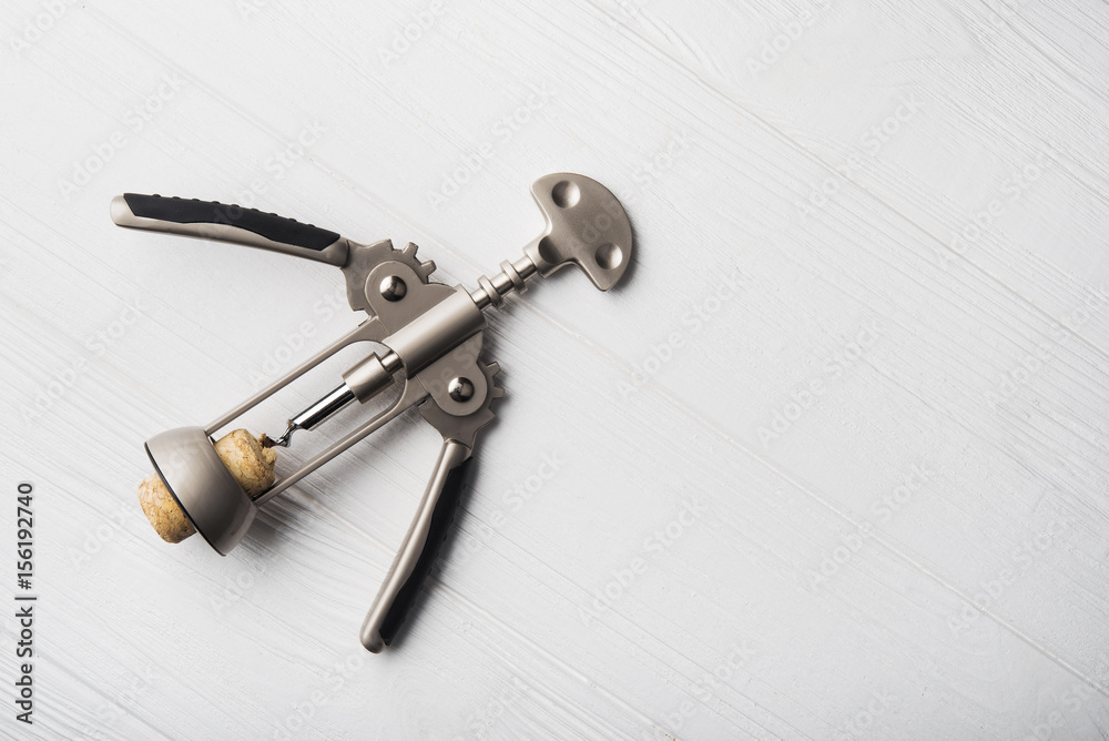 wine corkscrew on white wooden table wine corkscrew on white wooden table