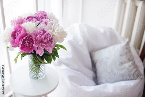 home decoration  fresh pink peonies on coffee table in white roo