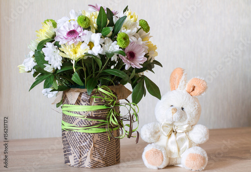 Wallpaper Mural Bouquet of different chrysanthemums in paper with bow on wood. Torontodigital.ca