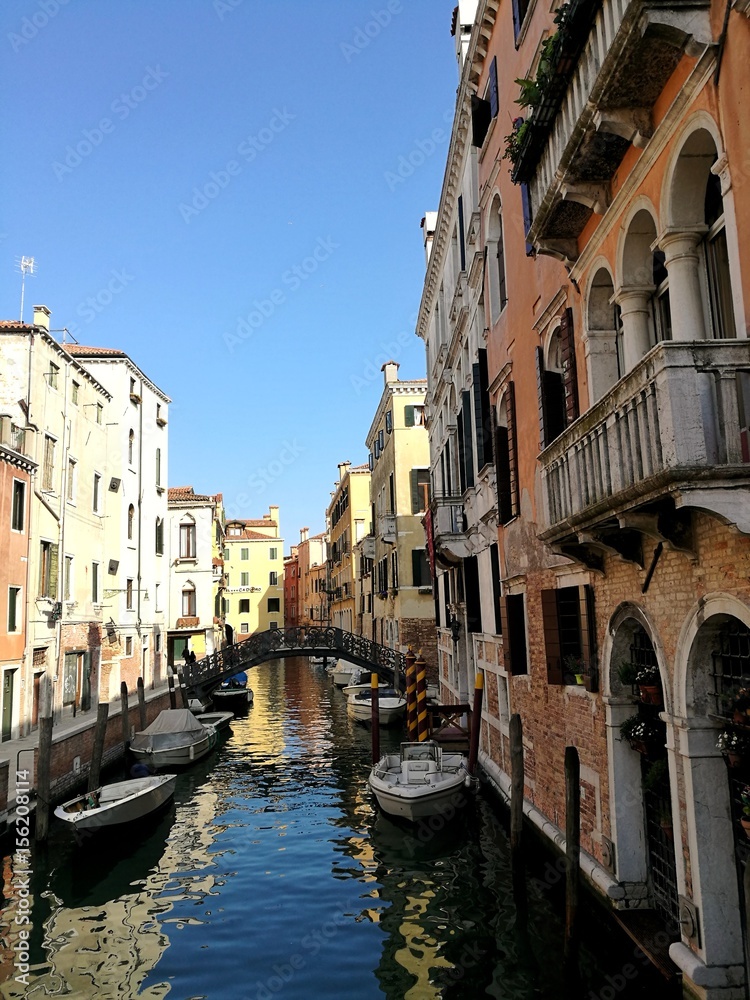VENICE, ITALY - MAY 18, 2017 : little canal of Venice with boats and bridge.
