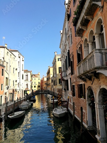 VENICE, ITALY - MAY 18, 2017 : little canal of Venice with boats and bridge.