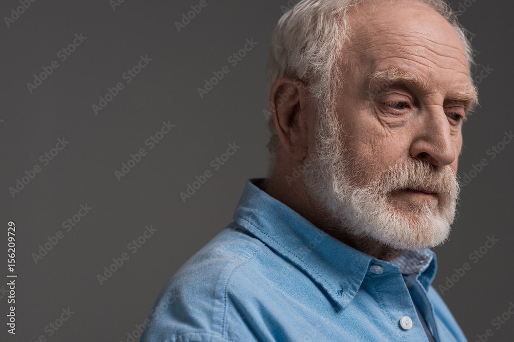 Obraz premium portrait of senior bearded man isolated on grey in studio