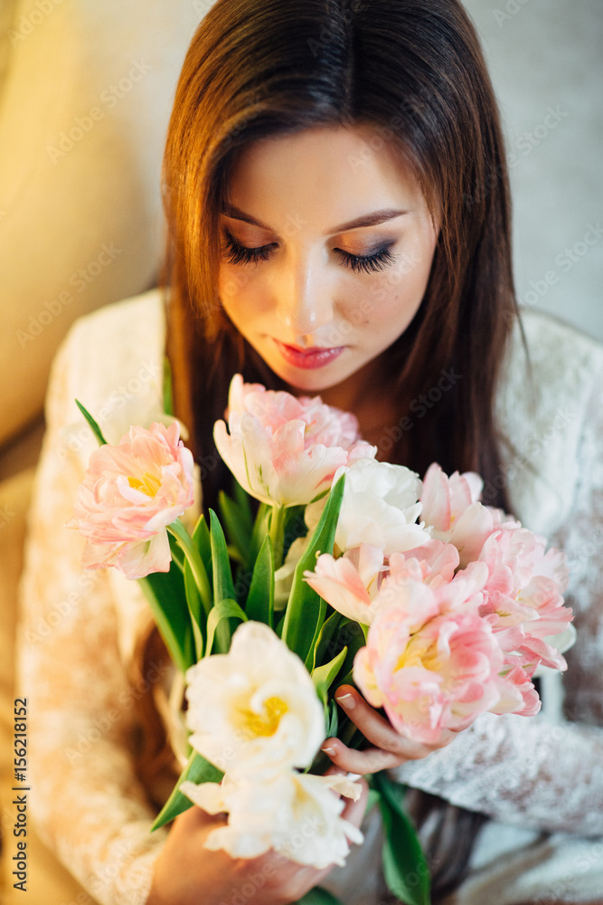 The charming girl looking at  bouquet